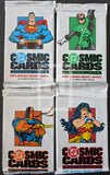 Four packs of Cosmic Cards featuring superhero characters on a black background.