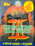 Topps Teenage Mutant Ninja Turtles trading card book with four turtles on a sunset background.