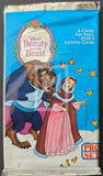 Pack of trading cards featuring Disney's 'Beauty and the Beast' with characters on a blue background.