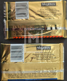 Two gold trading card packs from SkyBox International on a black background