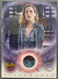 Trading card featuring a character from 'Buffy the Vampire Slayer' with a circular design and 'Pieceworks' text.