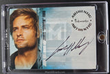 A collectible autographed trading card of Josh Holloway as James 'Sandy' Ford, sealed inside a clear protective plastic case. The card features a portrait of Josh Holloway on the left, a blue-toned textured background on the right, and a black ink signature across the lower right.