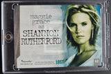 A collectible movie billiard card for Maggie Grace as Shannon Rutherford from the film Lost, housed in a clear plastic protective case. The card features a split design with a textured light gray/white background on the left and a portrait of Maggie Grace on the right, with the title 'LOST' and the 'A-3' denomination printed on it.