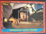 Trading card featuring a character in a car with 'Driving By Short Round' text, framed by decorative elements.