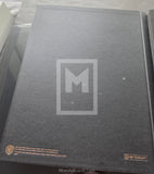 Gray book with a logo on the cover, featuring Warner Bros. branding.