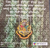 Hogwarts crest on a card with text about Harry Potter prop material