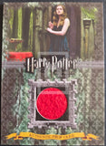 Harry Potter themed prop card with a woman standing in front of a green curtain.
