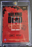 Trading card packaging for 'The Walking Dead' with Lennie James autograph, featuring red and black design.