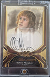 Trading card featuring Dominic Monaghan as Merry from 'The Lord of the Rings' with autograph and branding details.