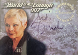 Card featuring a woman with 'The World Is Not Enough' text and '007' branding, signed by Judi Dench.