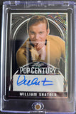 Trading card of William Shatner with autograph, framed by a clear border.