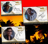 Three Jurassic Park autograph trading cards featuring Sam Neill, Samuel L. Jackson, and Jeff Goldblum, displayed against a red and orange background with black silhouettes.