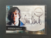 Autographed card of Andrew Wells with a signature and cityscape background