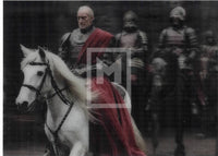 Man on a white horse with armored followers in a dark setting