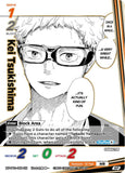 A trading card featuring a black-and-white manga-style portrait of Kei Tsuchikishima with speech bubbles and game text. The card includes character name text, stats, and printed borders, photographed or scanned against a dark background.