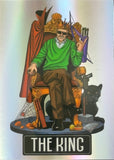 Card featuring a king figure with a green sweater, brown pants, and a crown, sitting on a throne with a black panther beside him.